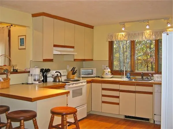 a kitchen with a sink a counter top space and appliances