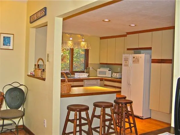 a view of a kitchen with kitchen island dining table and chairs
