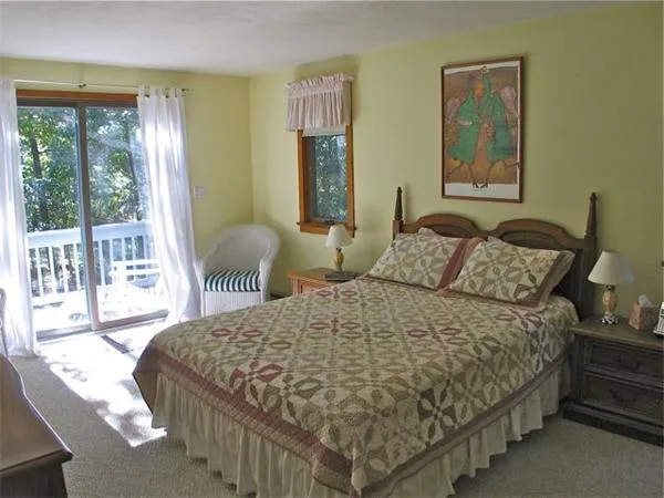 a bedroom with a bed and glass window