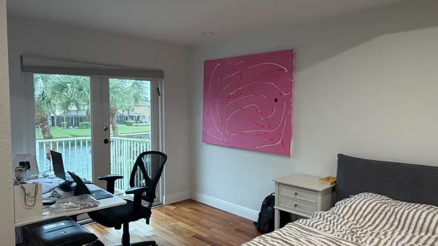 a view of a workspace with furniture and a window