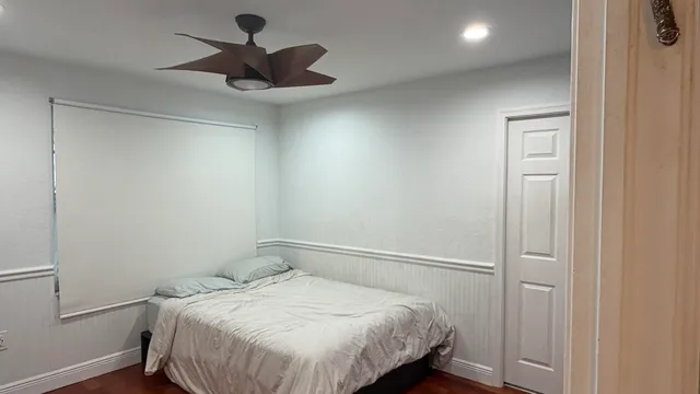 a bedroom with a bed and a chandelier