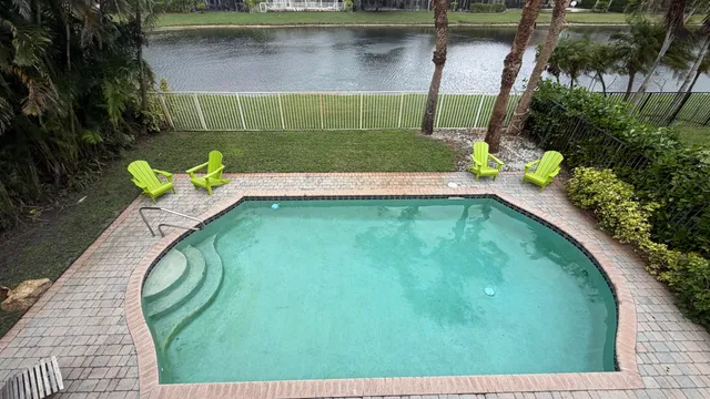 a view of a swimming pool with a outdoor seating
