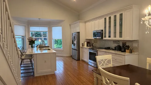 a kitchen with stainless steel appliances granite countertop a refrigerator stove top oven and sink