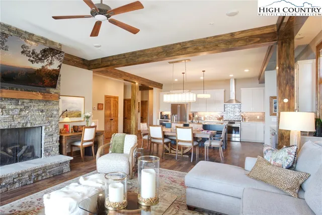 a living room with furniture kitchen view and a fireplace