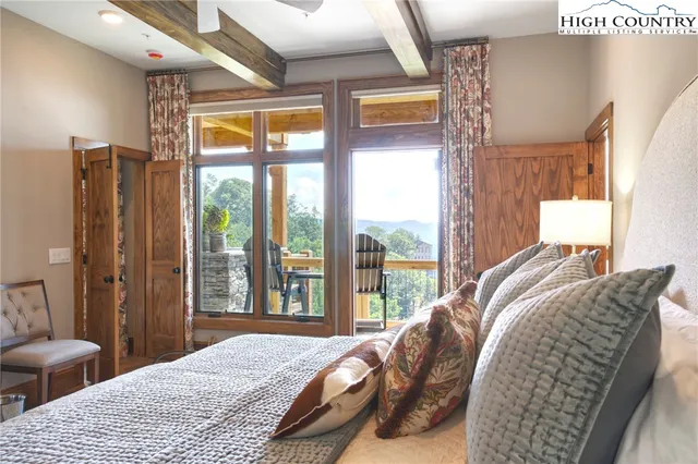 a bedroom with a bed and glass window