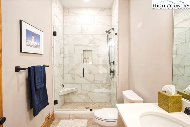 a bathroom with a toilet and shower