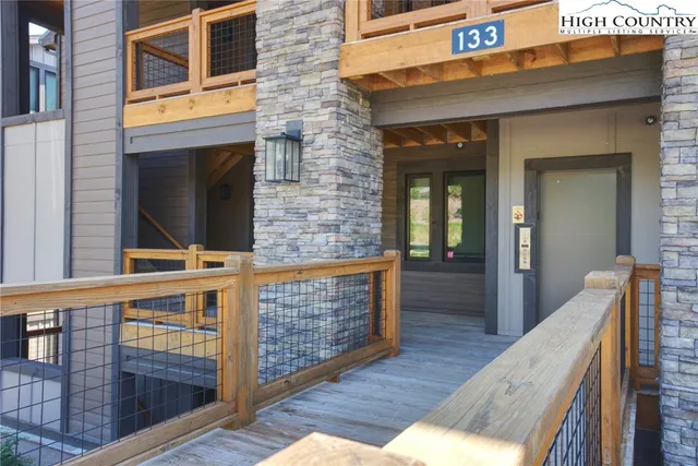 a view of living room kitchen and entryway