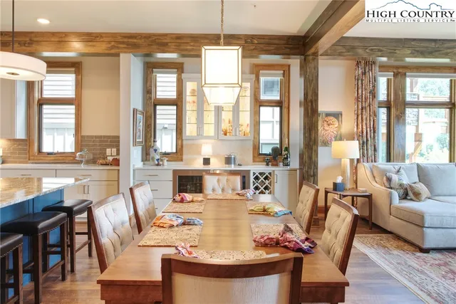 a living room with fireplace furniture and a large window