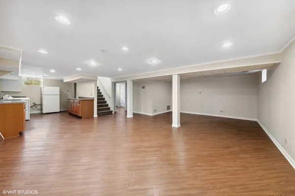 a view of kitchen and a refrigerator with wooden floor
