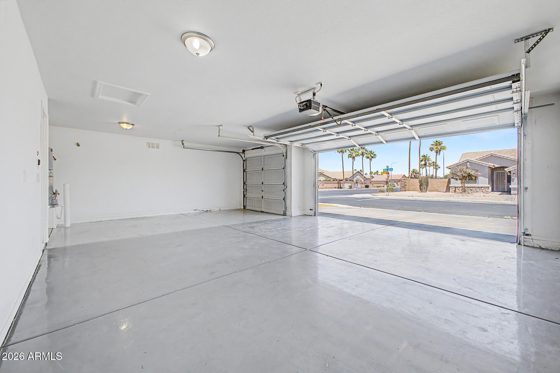 11199 West Monte Vista Road Avondale, AZ 85392 - Photo 27 of 36 a garage with white cabinets and wooden floor