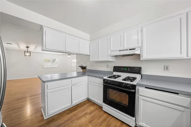 a kitchen with cabinets appliances and a sink