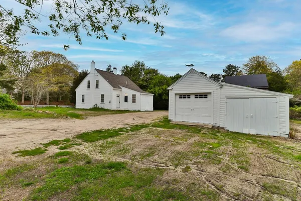 an aerial view of a house with a yard and garden