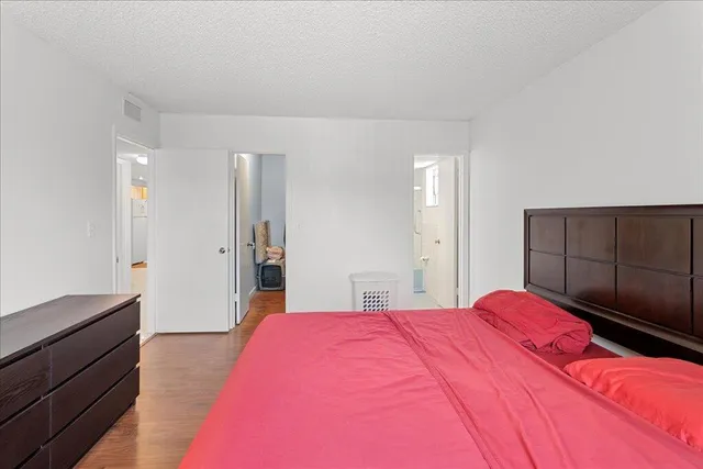 a bedroom with a bed and a dresser