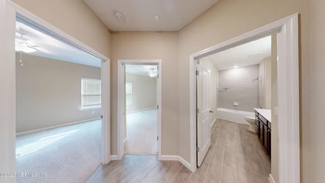a view of a hallway with furniture