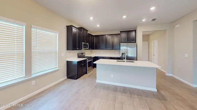 a view of a big room with windows and closet
