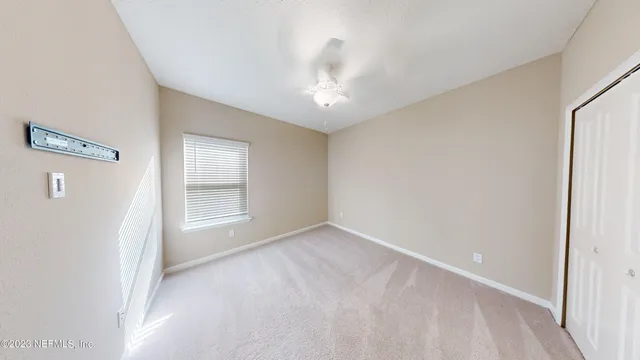 an empty room with windows and entryway