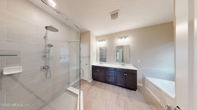 a bathroom with a glass shower door