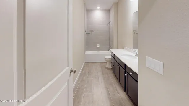 a bathroom with a double vanity sink mirror and shower