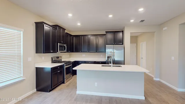 a kitchen with cabinets stainless steel appliances and wooden cabinets