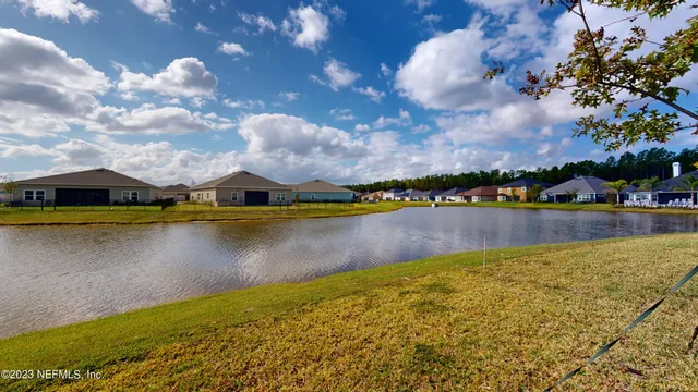 a view of a lake with houses in the back