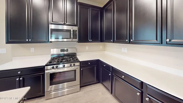 a kitchen with granite countertop a refrigerator and a sink