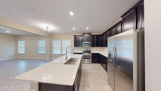 a kitchen with granite countertop stainless steel appliances and wooden cabinets