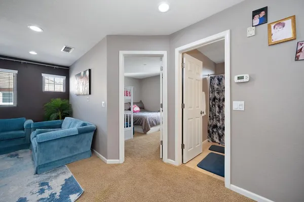 a living room with furniture and a glass door