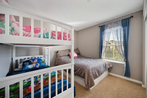 a bedroom with two beds and a window