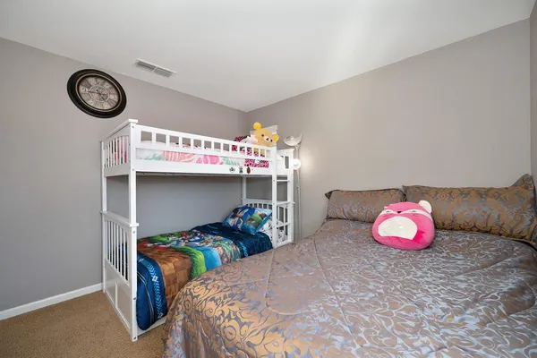 a bedroom with furniture and a fan