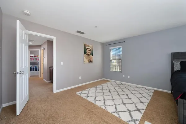 a bedroom with a bed and a tv on the dresser