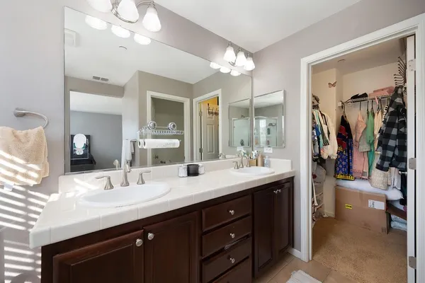 a bathroom with a sink double vanity and a mirror