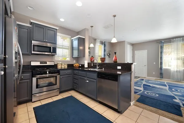 a kitchen with a sink stove and microwave