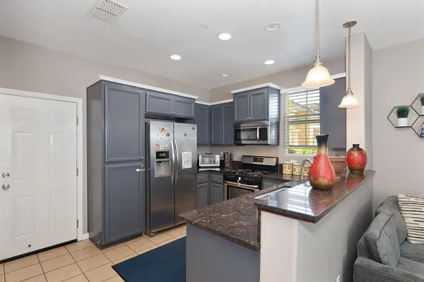 a kitchen with refrigerator and cabinets