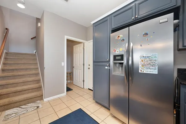a view of a hallway with wooden cabinets