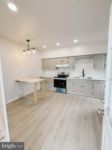 a view of kitchen with wooden floor