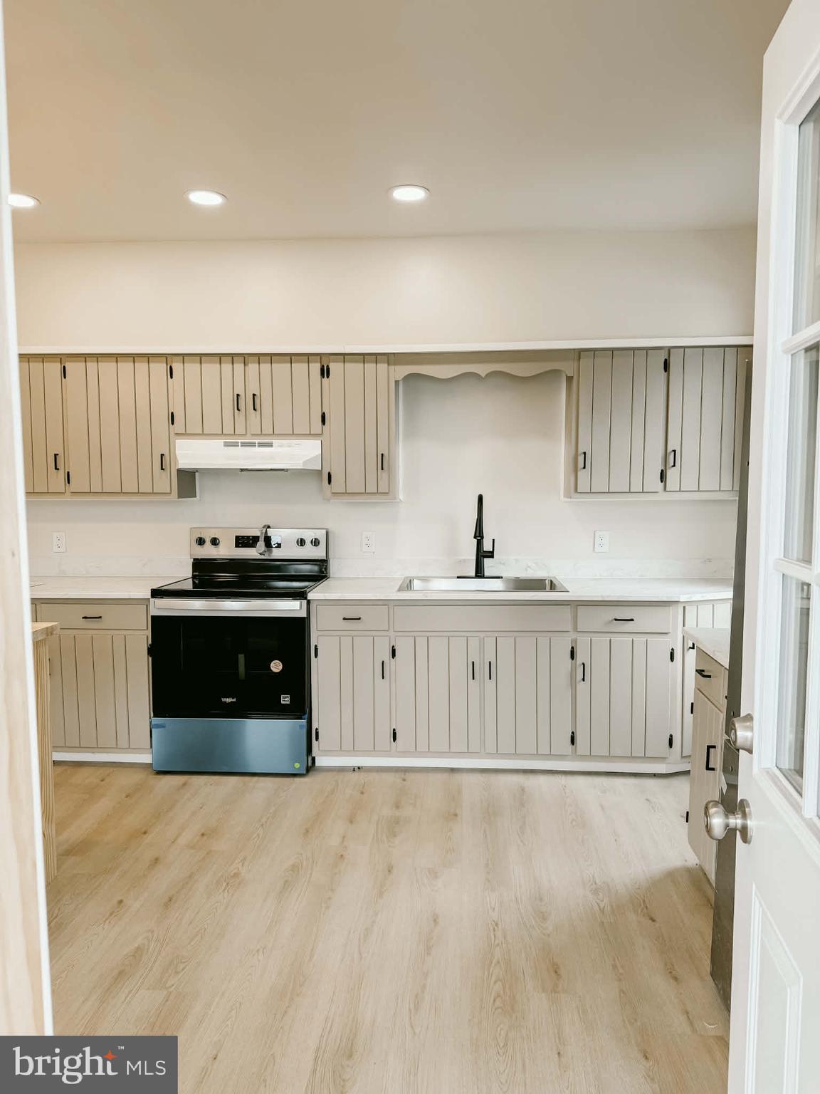 119 South Walnut Street Lewistown, PA 17044 - Photo 5 of 29 a kitchen with kitchen island granite countertop a stove a sink and a refrigerator