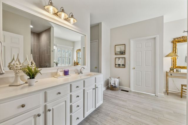 a bathroom with a double vanity sink and a mirror