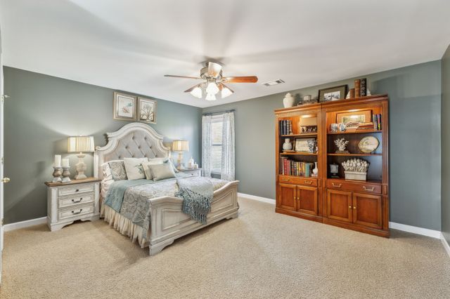 a spacious bedroom with a bed and cabinets