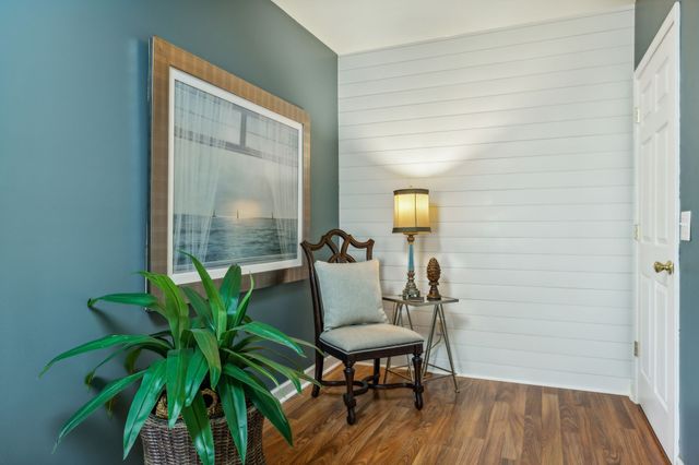 a view of a livingroom with furniture and a potted plant