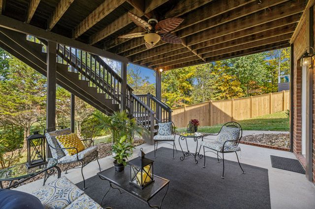 a roof deck with table and chairs and wooden floor