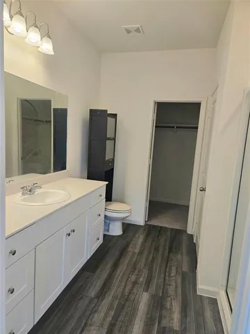 a view of walk in closet with empty racks