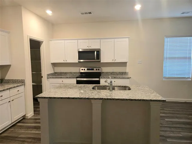 a kitchen with a refrigerator and a sink