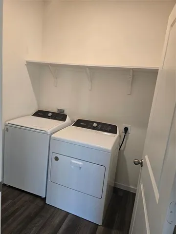 a view of a kitchen with kitchen island a sink wooden floor and a counter top space