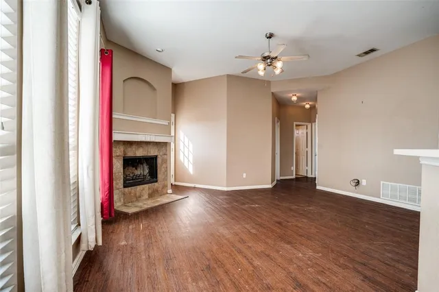 a view of a kitchen with wooden floor and a ceiling fan