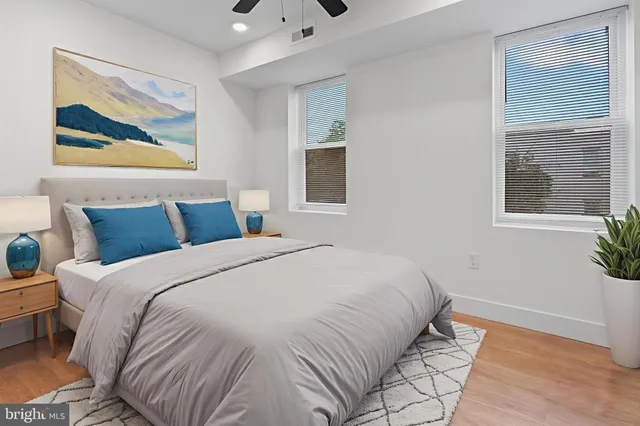 a bedroom with bed and wooden floor