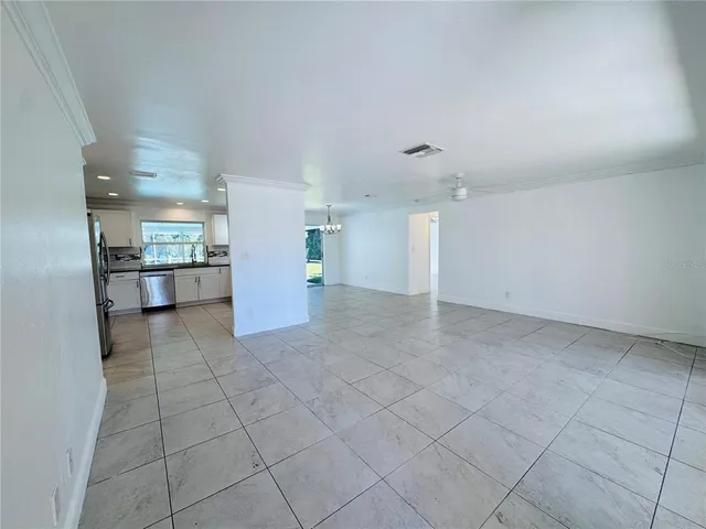 a view of a kitchen with a sink and a refrigerator