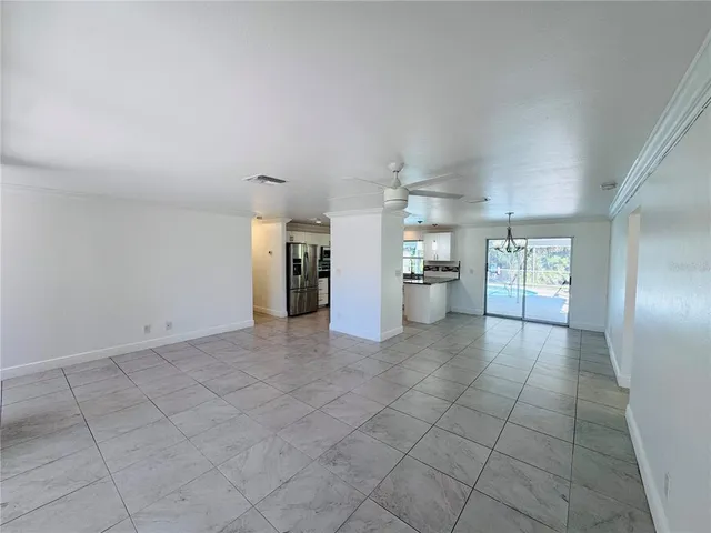 a view of a kitchen with refrigerator and more cabinets
