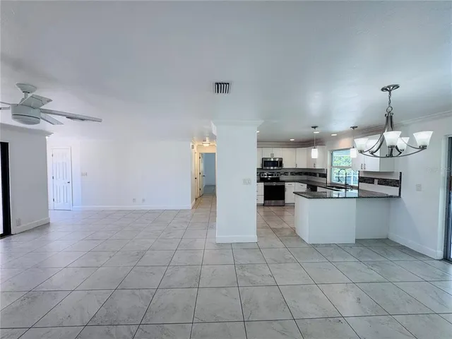 a large kitchen with white cabinets and a sink