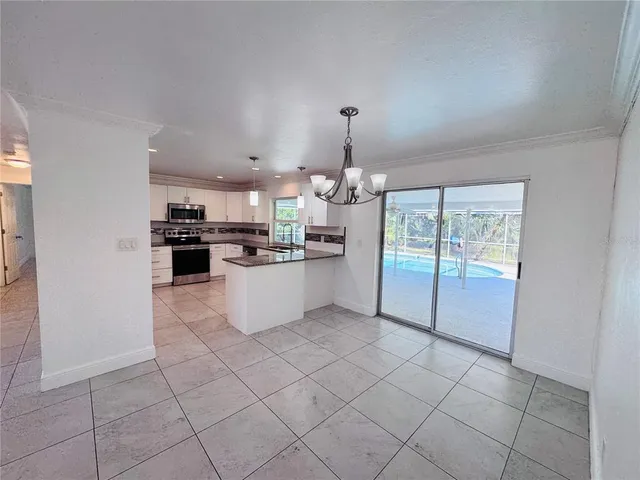 a kitchen with stainless steel appliances a refrigerator sink and cabinets