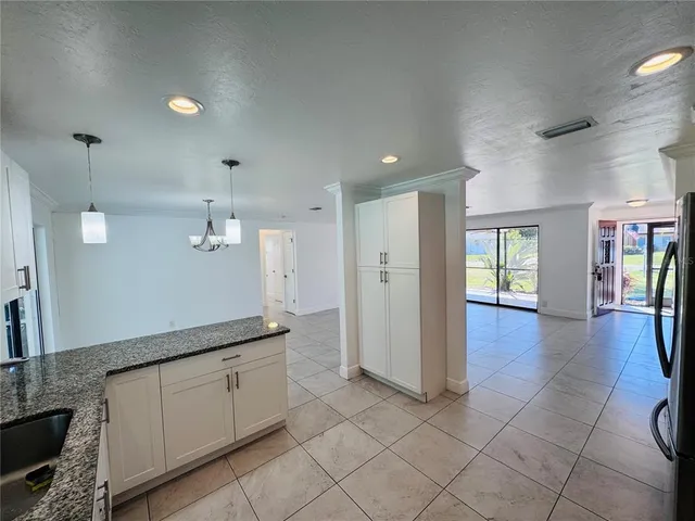 a view of a kitchen with granite countertop cabinets